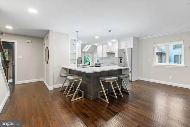 a dining room with furniture and wooden floor