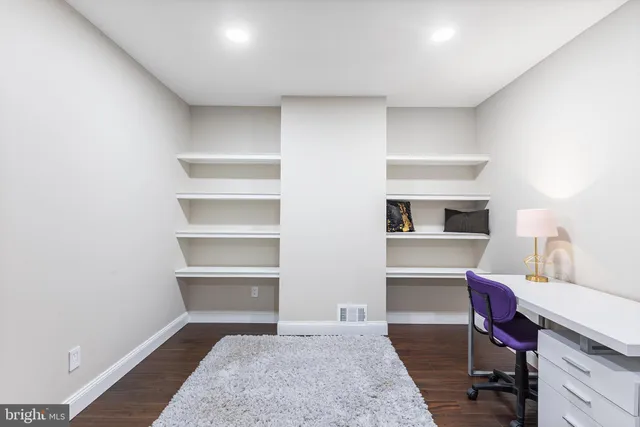 a living room with furniture and a dining table