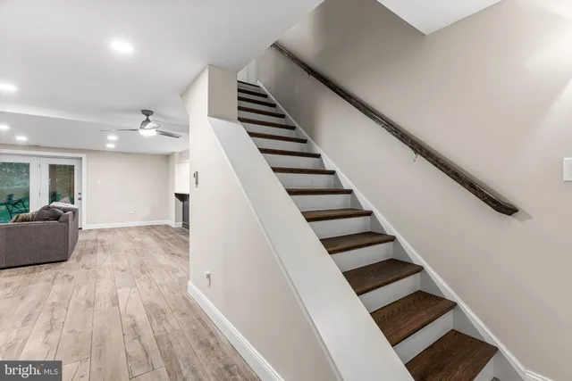 a kitchen with a sink and wooden floor