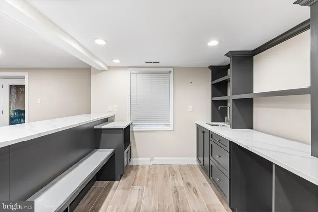 a kitchen with stainless steel appliances kitchen island a cabinets and wooden floor