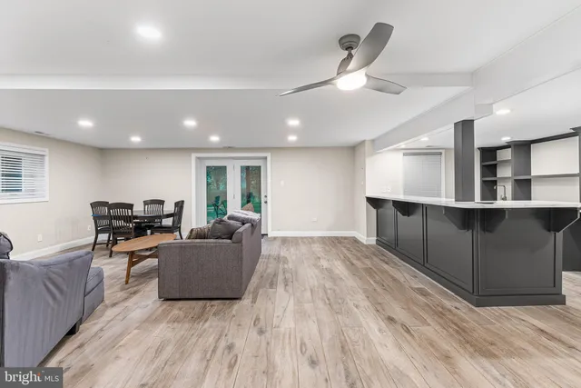 a bathroom with a sink vanity granite toilet and a mirror