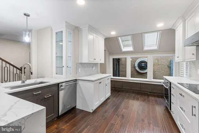 a kitchen with a sink stove and cabinets