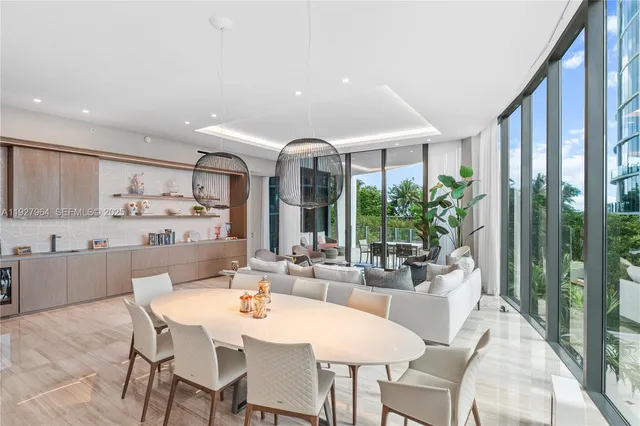 a dining room with furniture a rug and a large window