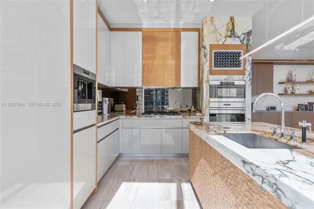 a kitchen with stainless steel appliances granite countertop a sink stove and cabinets