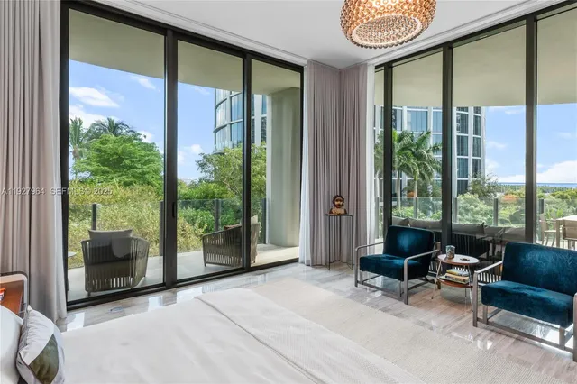 a living room filled with furniture and a potted plant