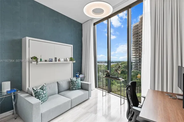 a living room with furniture and a floor to ceiling window