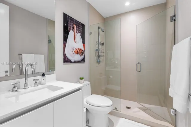 a bathroom with a sink toilet and shower