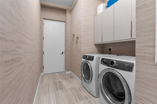 a view of storage and utility room with washer and dryer
