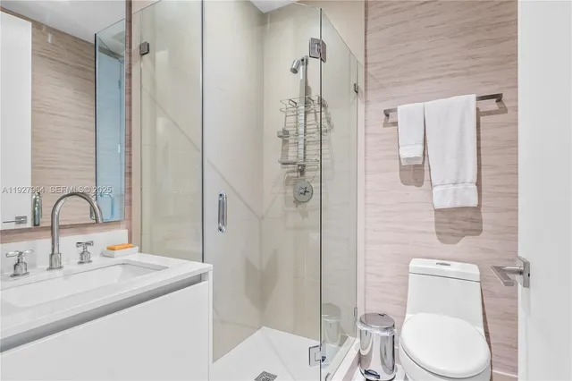 a bathroom with a sink toilet and shower