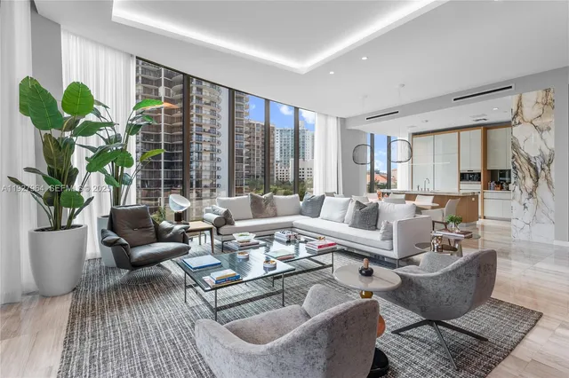 a living room with furniture potted plant and a large window