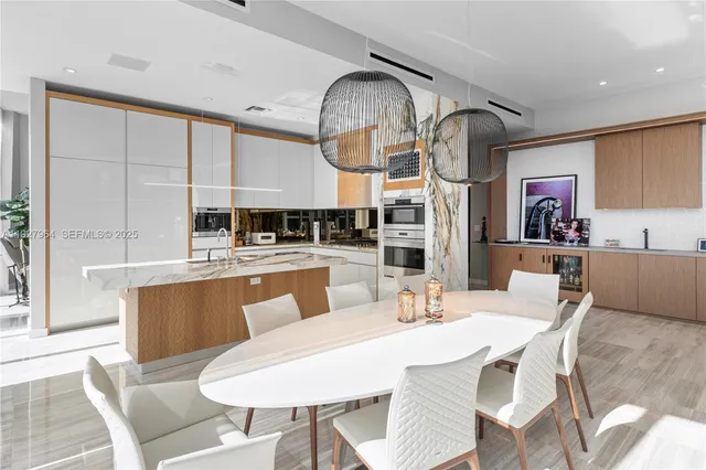 a large kitchen with a table and chairs