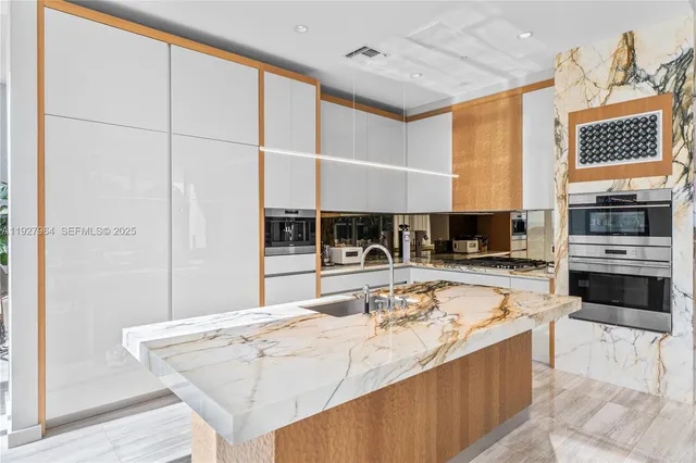 a large kitchen with kitchen island a sink stainless steel appliances and cabinets