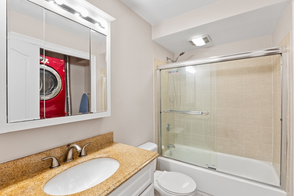 7 Fox Street, Unit PH Boston, MA 02122 - Photo 12 of 24 a bathroom with a granite countertop tub sink and mirror