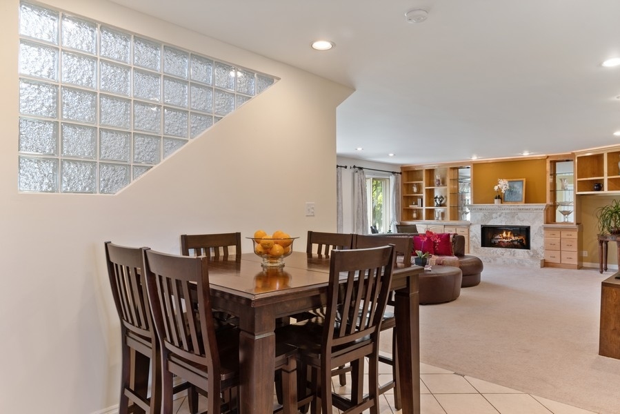120 Chestnut Road Northbrook, IL 60062 - Photo 9 of 22 a view of a dining room with furniture and a fireplace