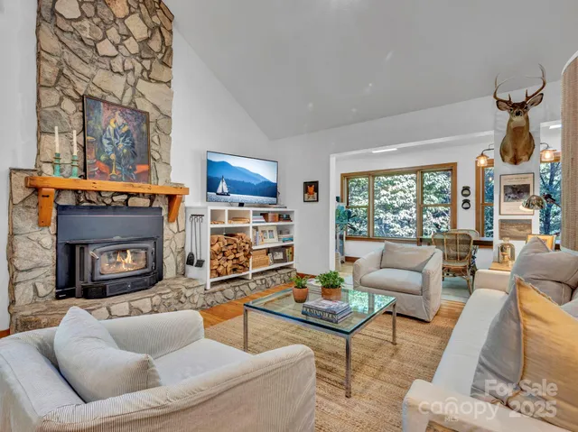 a kitchen with stainless steel appliances granite countertop a stove a sink dishwasher and a microwave oven with white cabinets