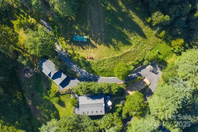 an aerial view of residential house with swimming pool and lawn chairs