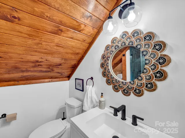 a bedroom with a bed and large windows