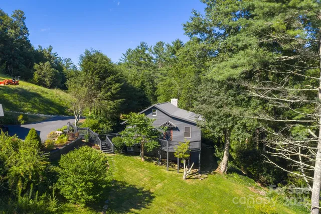 an aerial view of a house with swimming pool and garden