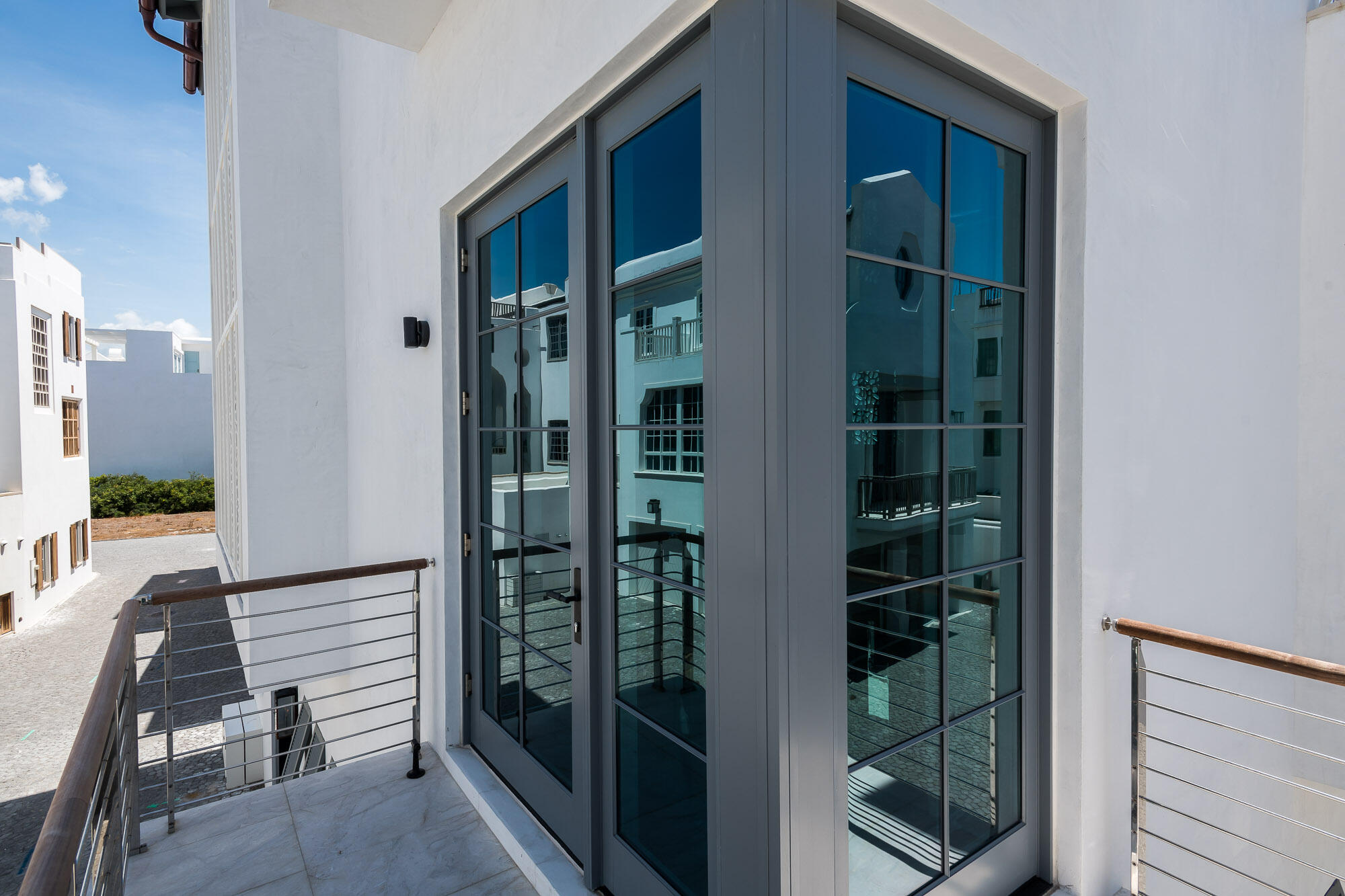 23 Sea Venture Alley, Unit MM6 Inlet Beach, FL 32461 - Photo 43 of 82 a view of a hallway with wooden floor and glass door