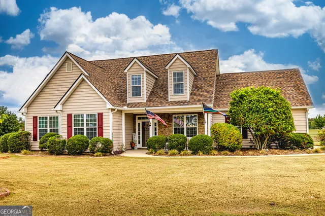 a front view of house with yard and green space