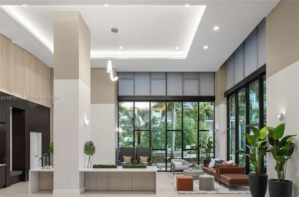 a living room with furniture and large windows