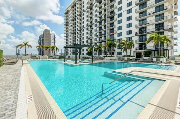 a view of swimming pool with outdoor seating and city view