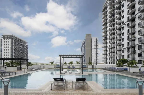 a view of a swimming pool with outdoor seating