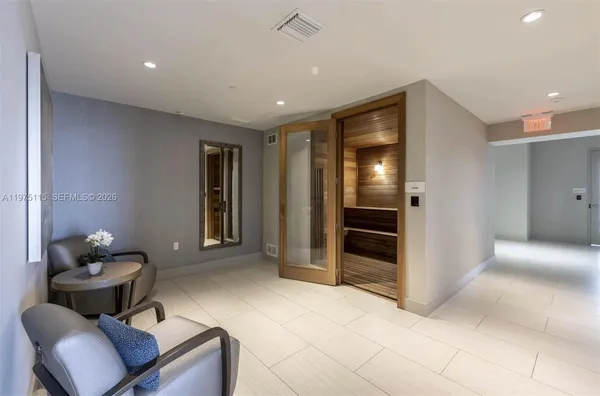 a living room with furniture and a walk in closet