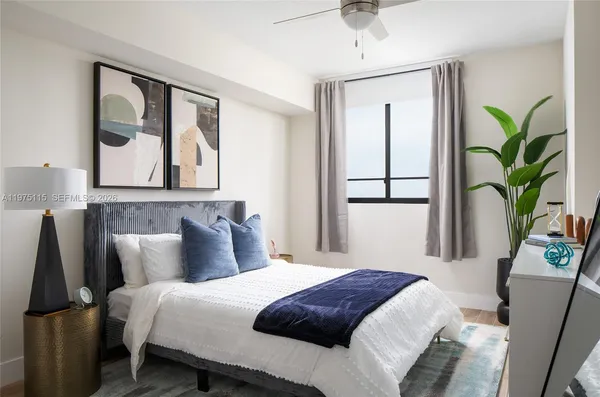 a bedroom with a bed and a large mirror