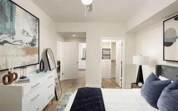 a spacious bedroom with a bed and a chandelier