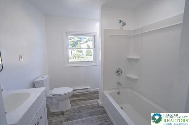 a bathroom with a sink a toilet and bathtub