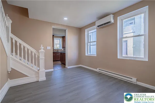 a view of an entryway with wooden floor and windows