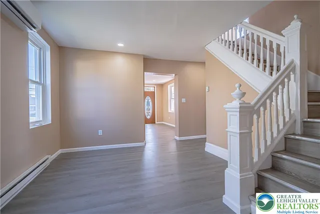 a view of an entryway with wooden floor