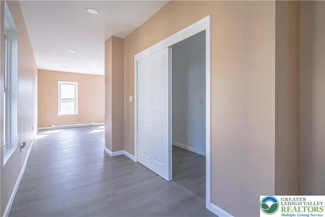 a view of an empty room with wooden floor