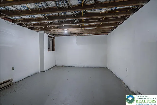 a view of a dry yard with plants and trees