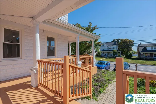 a view of a house with a porch and furniture