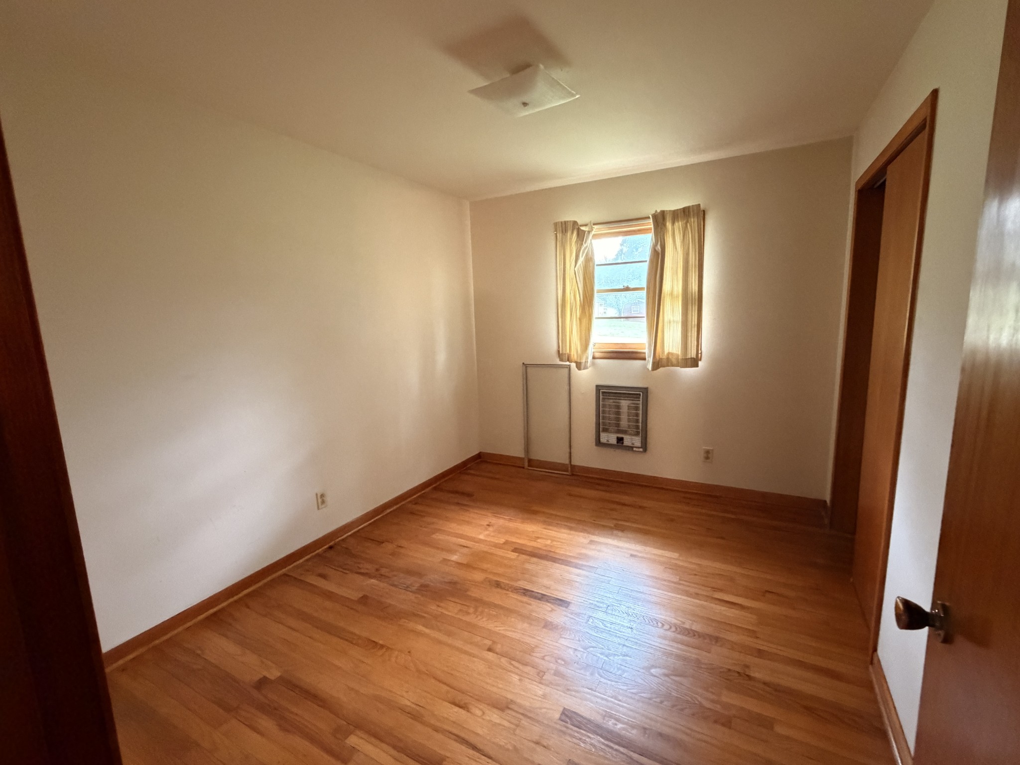 955 Rocky Road Pulaski, TN 38478 - Photo 7 of 10 an empty room with wooden floor and windows
