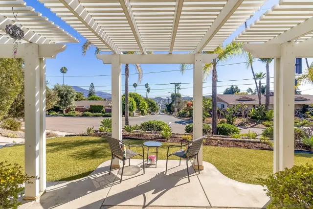 a view of a patio with a table and chairs