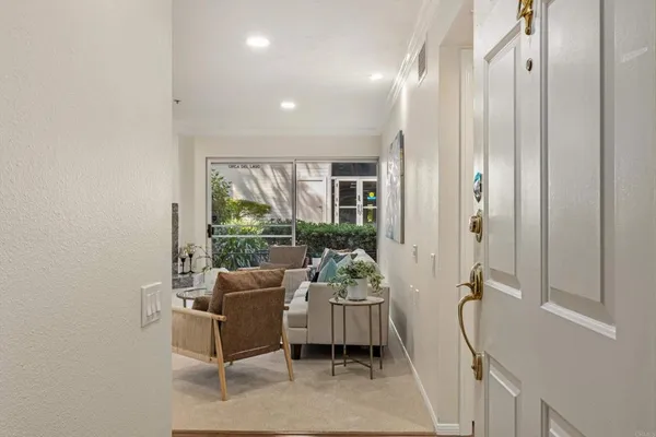 a dining room with furniture and a large window