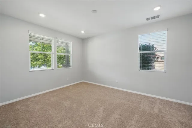a bathroom with a granite countertop sink toilet a large mirror a shower and a window