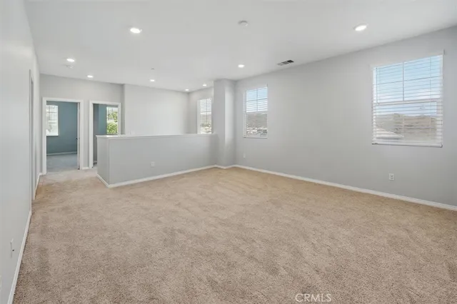 a bedroom with a bed and glass walk in closet