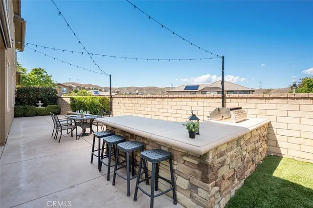 a view of a patio with couches table and chairs and potted plants