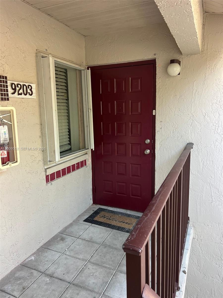 9203 Southwest 138th Place, Unit 9203 Miami, FL 33186 - Photo 1 of 22 a view of a hallway with entryway
