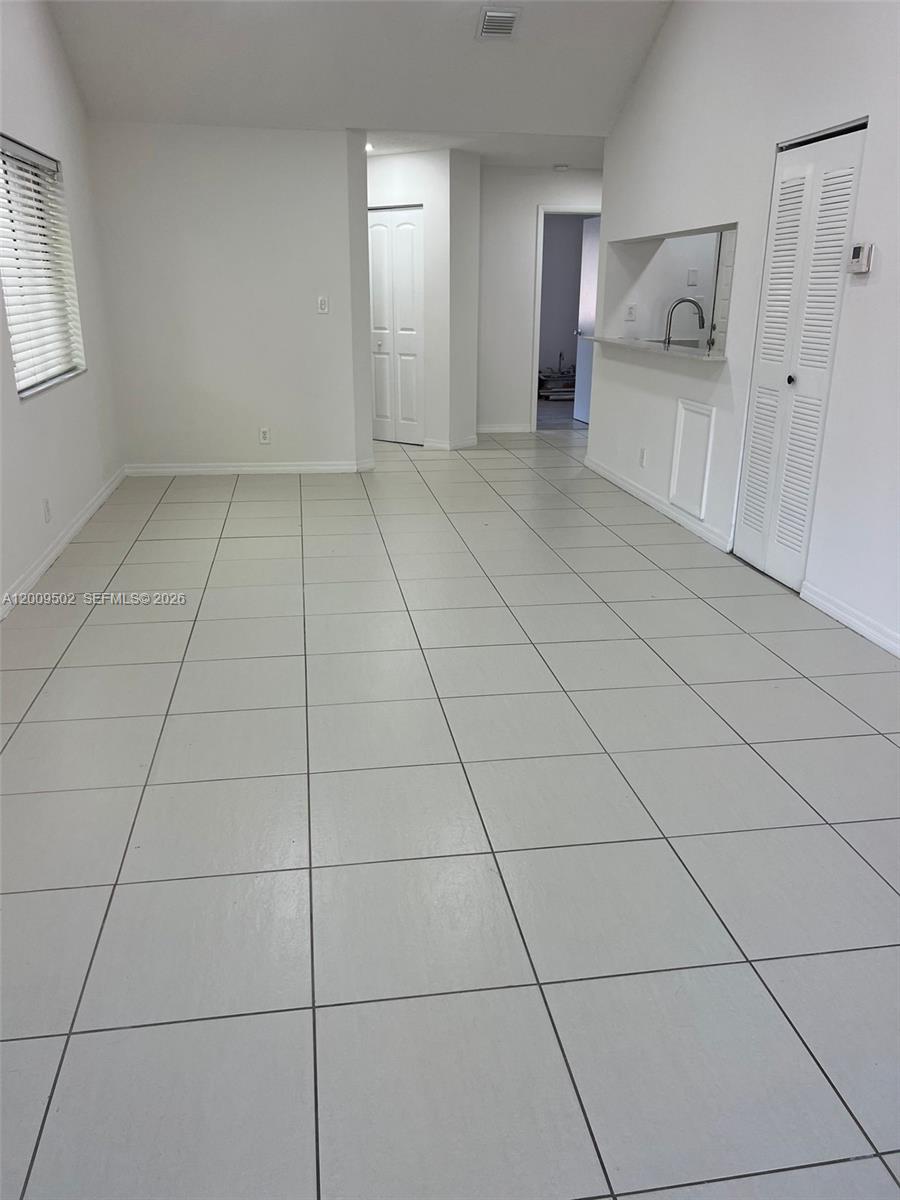 9203 Southwest 138th Place, Unit 9203 Miami, FL 33186 - Photo 14 of 22 a view of an empty room with a window