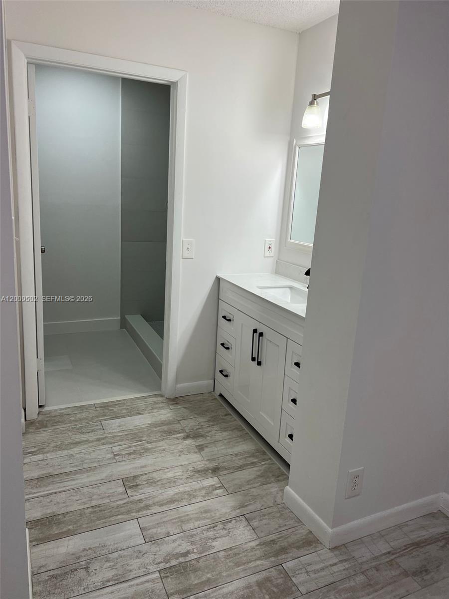 9203 Southwest 138th Place, Unit 9203 Miami, FL 33186 - Photo 17 of 22 an empty room with mirror