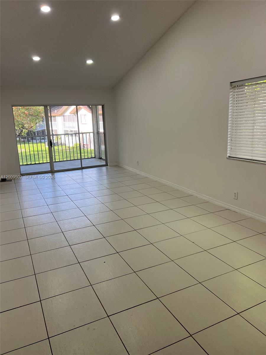 9203 Southwest 138th Place, Unit 9203 Miami, FL 33186 - Photo 18 of 22 a view of an empty room and a window