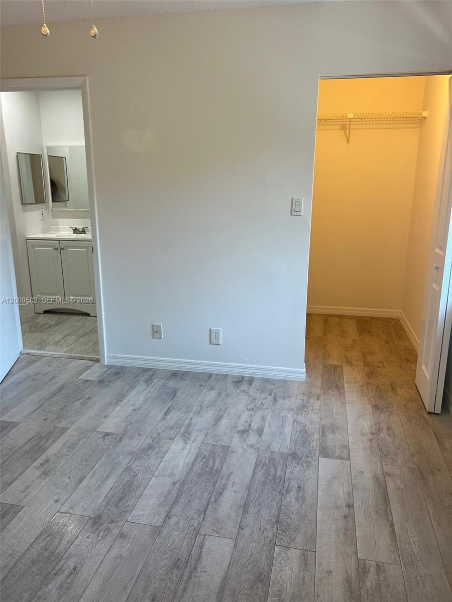 9203 Southwest 138th Place, Unit 9203 Miami, FL 33186 - Photo 22 of 22 an empty room with a bathroom and mirror
