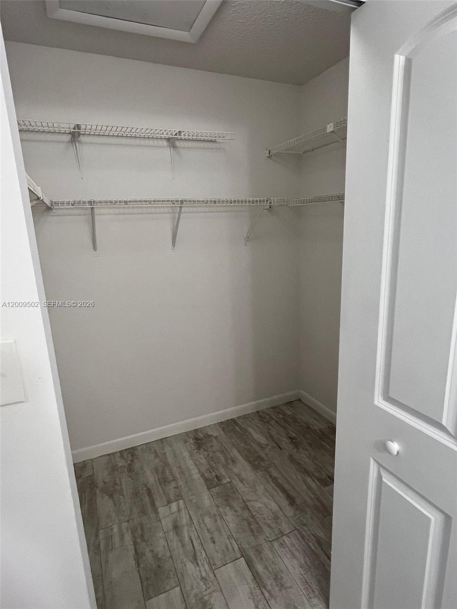 9203 Southwest 138th Place, Unit 9203 Miami, FL 33186 - Photo 3 of 22 a view of a room with racks on the wall