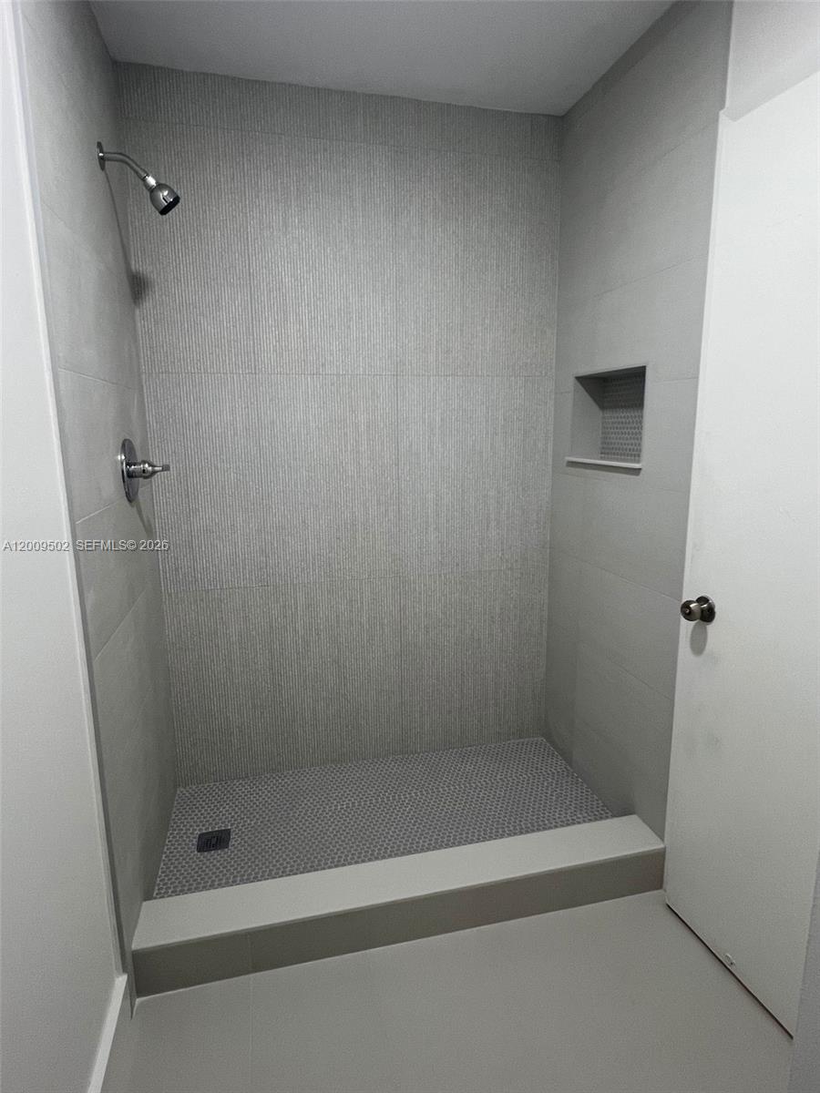 9203 Southwest 138th Place, Unit 9203 Miami, FL 33186 - Photo 7 of 22 a bathroom with a shower