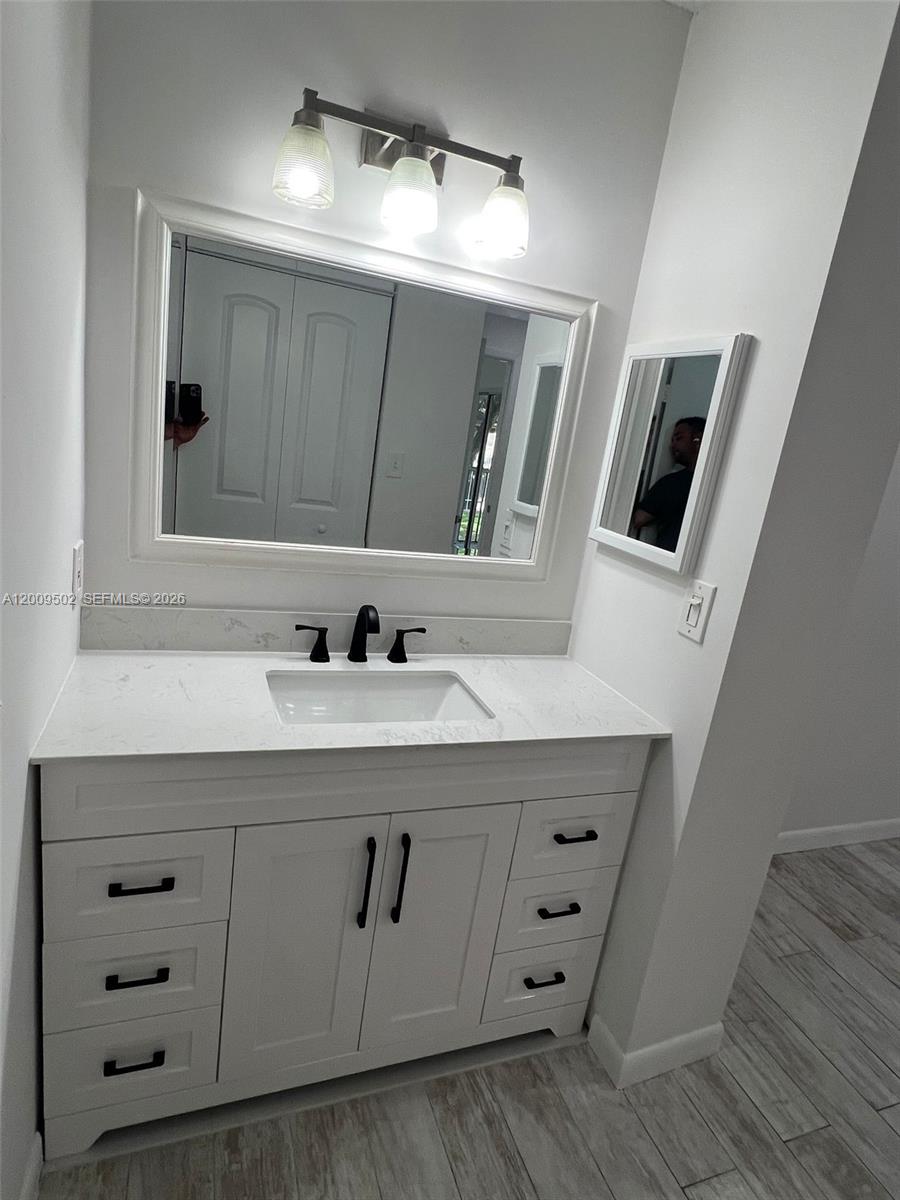 9203 Southwest 138th Place, Unit 9203 Miami, FL 33186 - Photo 8 of 22 a bathroom with a double vanity sink and mirror